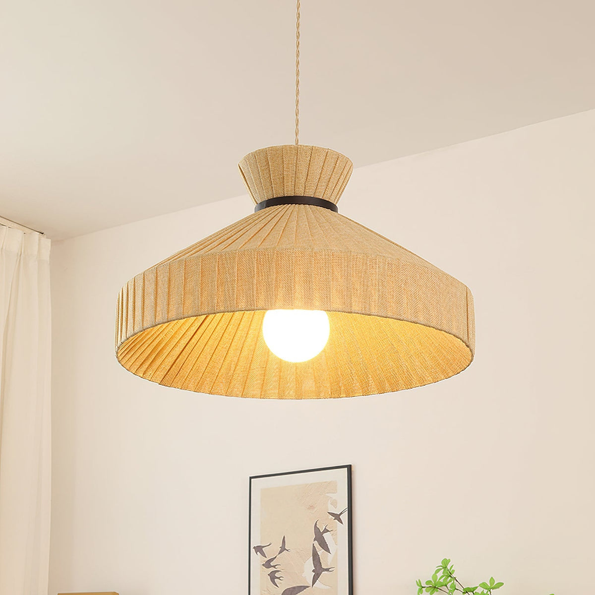 The Surora Pendant Light turned on, emitting a warm and cozy glow.