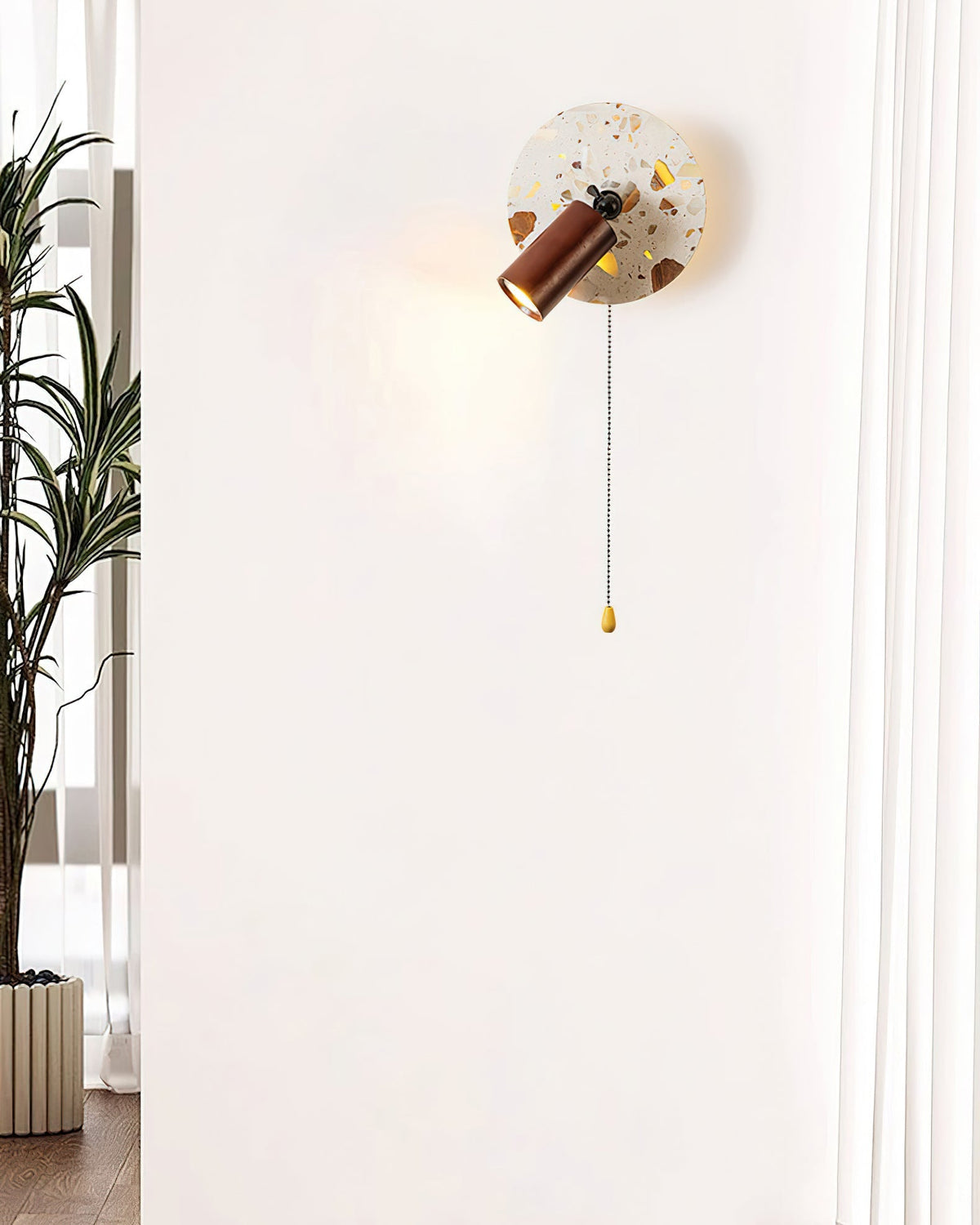 Lifestyle image of the Swizzle Wall Lamp providing ambient light in a bedroom.