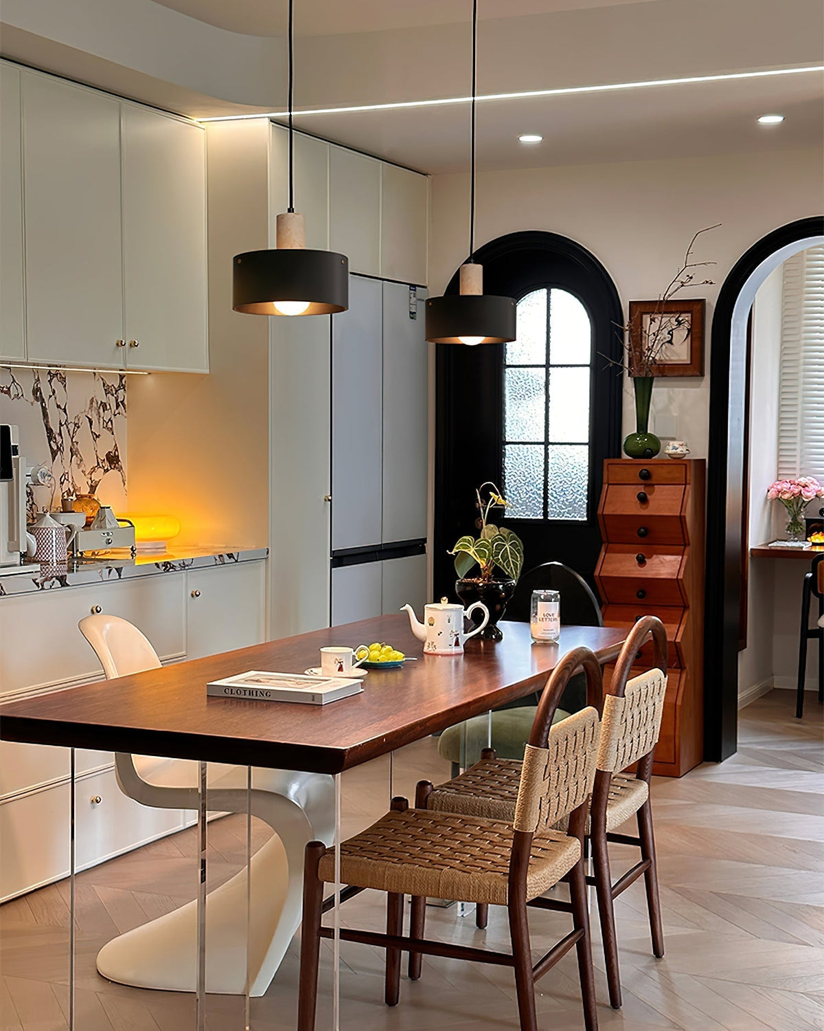 Lifestyle image of the Tako Pendant Lamp in a contemporary dining room setting.