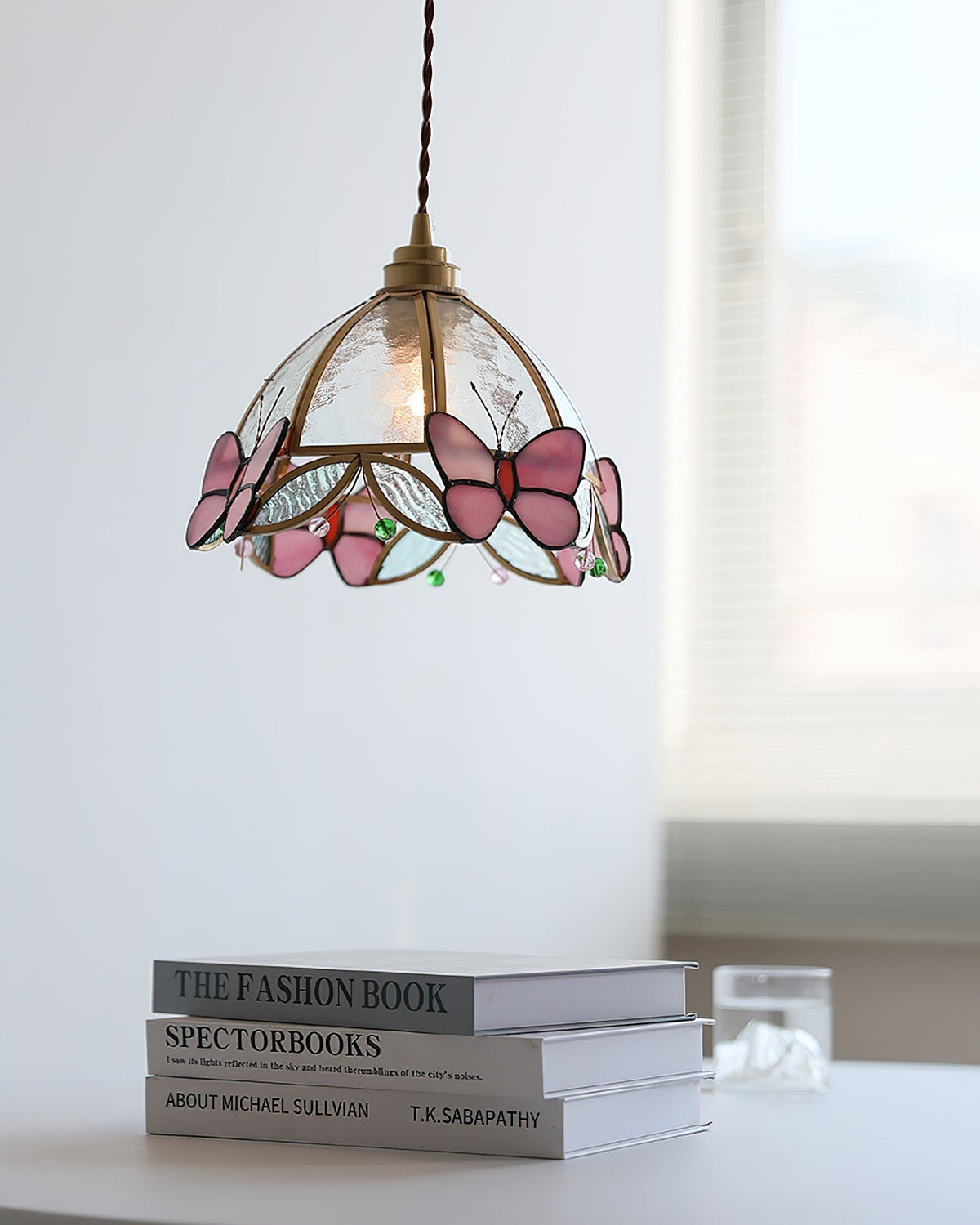 The Valinte pendant light illuminated, casting a warm, colorful glow.
