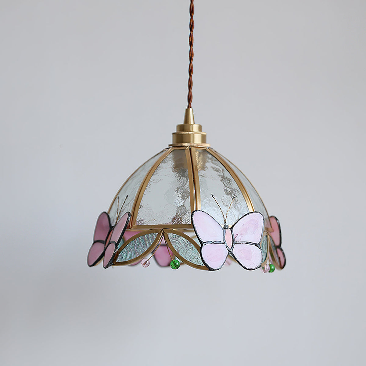 Valinte pendant light shown against a dark background to highlight its colors.