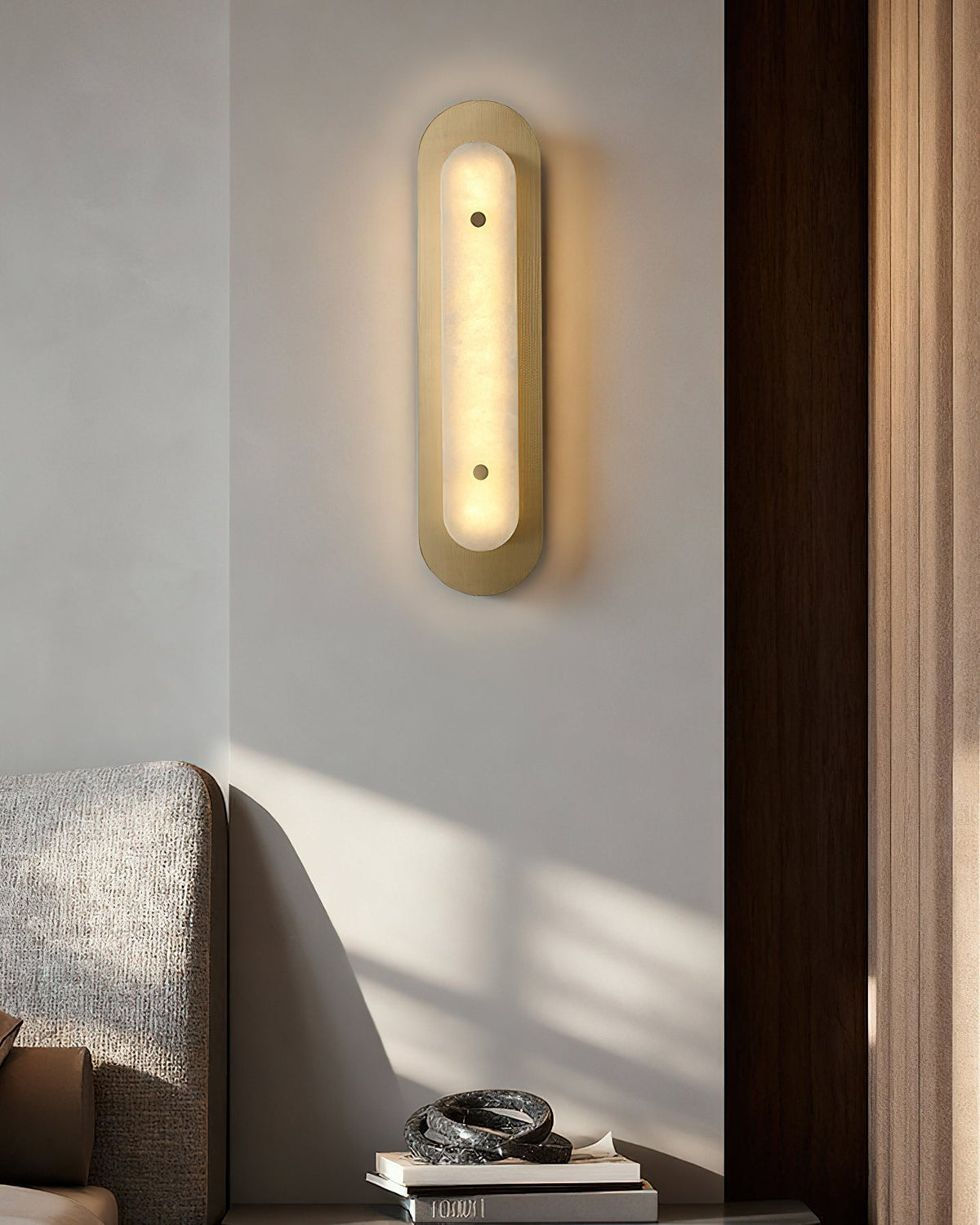 The Vance Alabaster Wall Lamp shown in a contemporary living room.