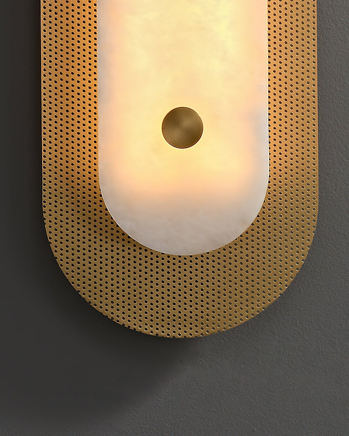 Vance Alabaster Wall Lamp illuminated, casting a warm glow.