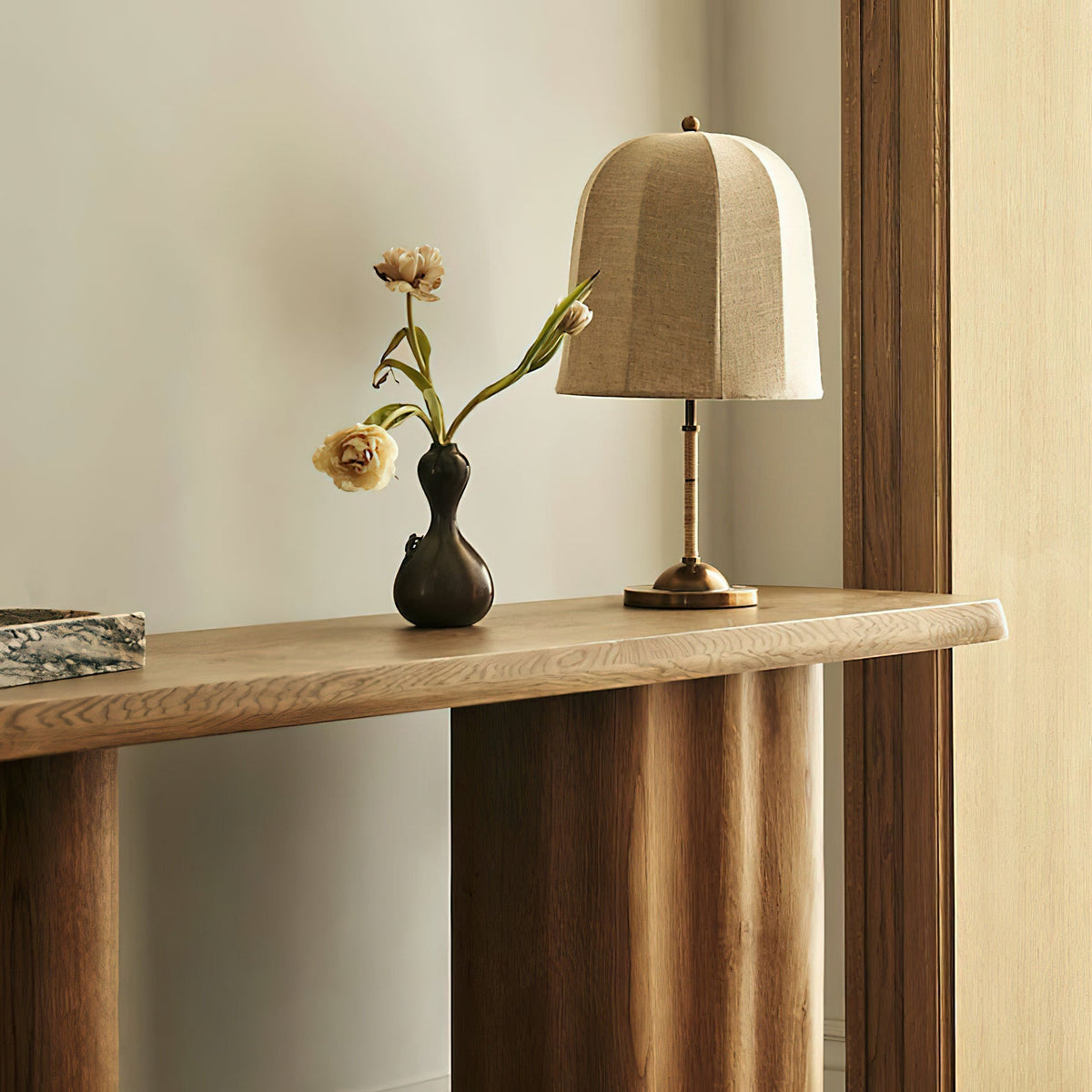 Vanna Table Lamp shown on a bedside table in a bedroom setting.