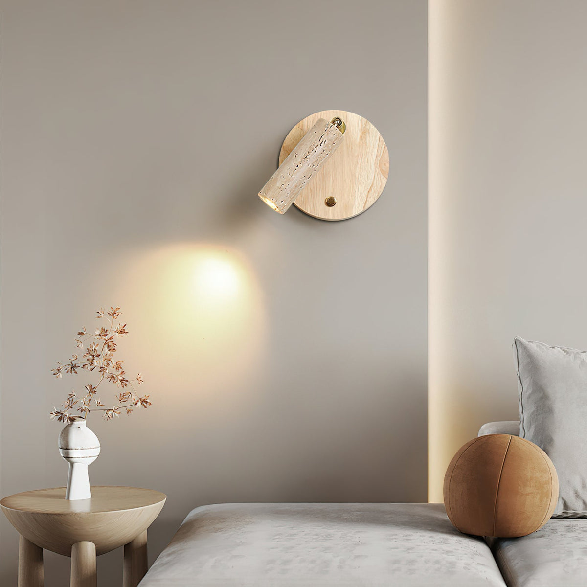 The wall lamp with the spotlight shade swiveled to the side to direct light.