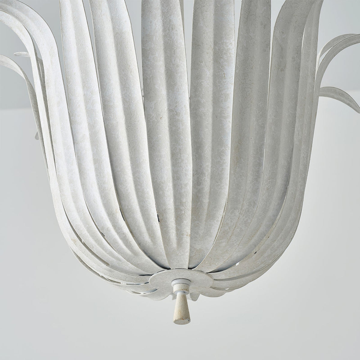 The white leaf pendant light in a minimalist dining area setting.