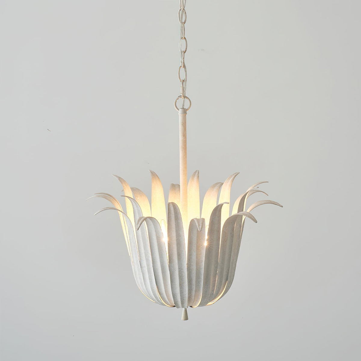 The gold leaf pendant light hanging in a stylish living room.