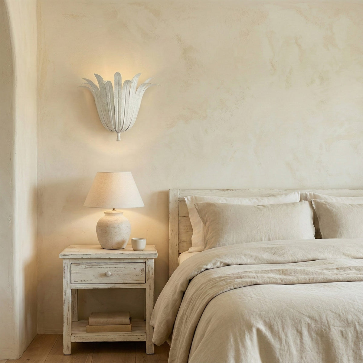 Close-up of the white metal leaves on the Vicenzio wall lamp.
