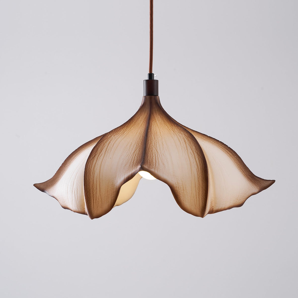 Another lifestyle view of the Viscontea Pendant in a cozy reading nook.