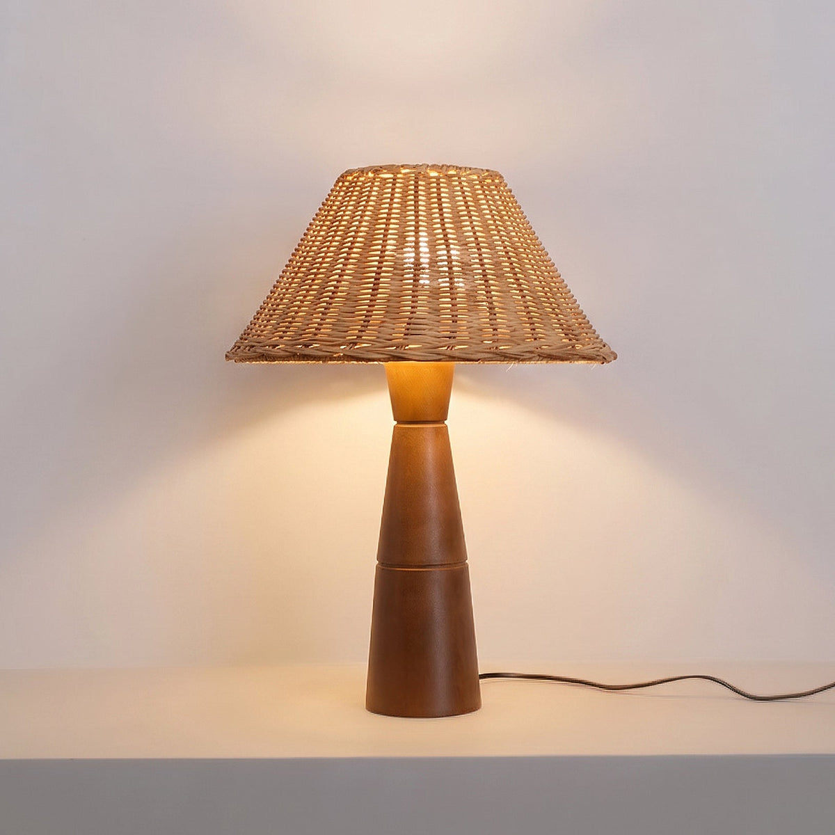 The Zaya Table Lamp on a side table next to a book.