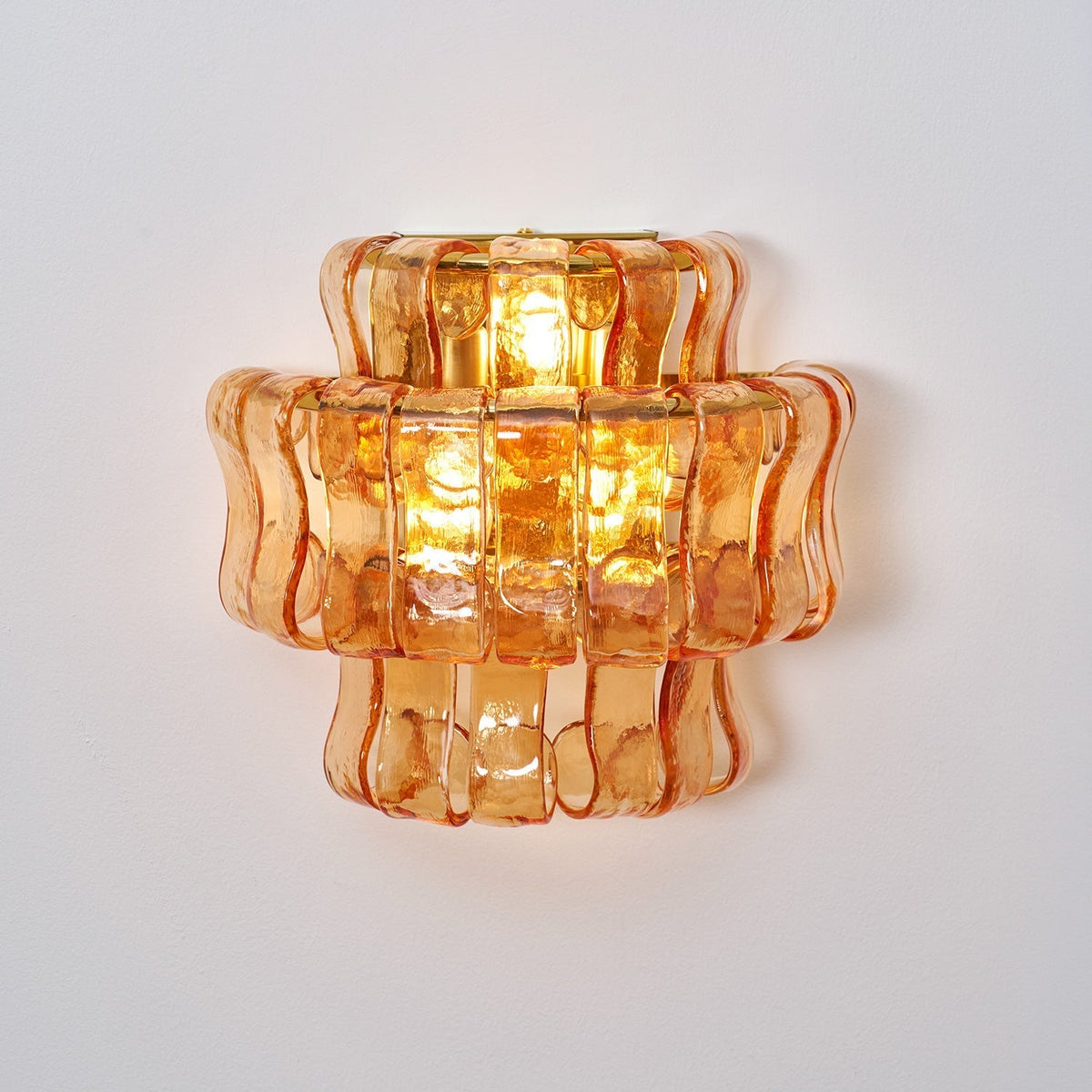 Angled shot of the clear glass Albano Wall Lamp.