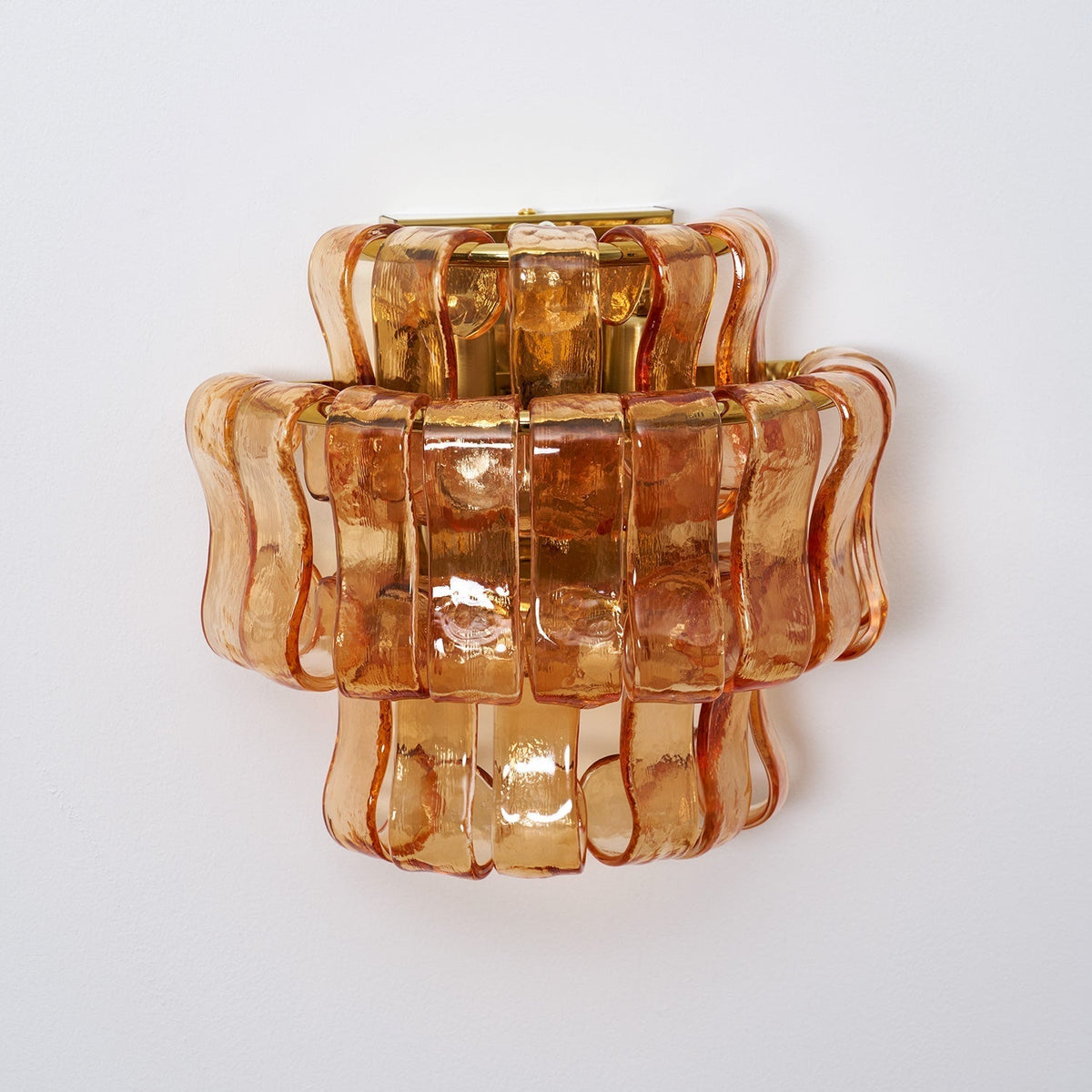 Angled shot of the amber glass Albano Wall Lamp.
