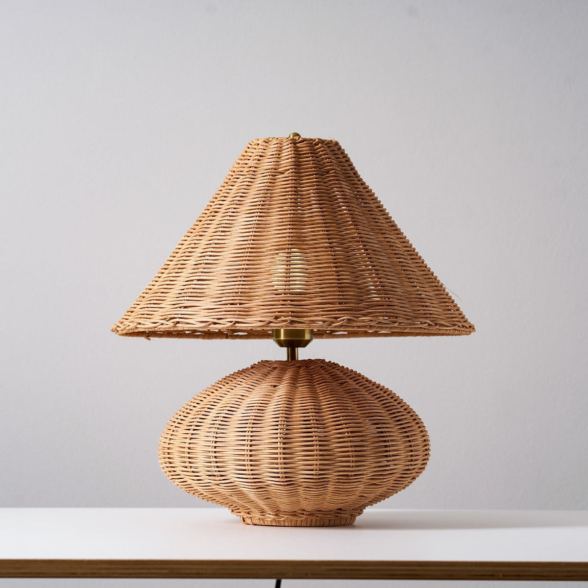 The soft, textured light pattern cast by the lamp on a nearby wall.