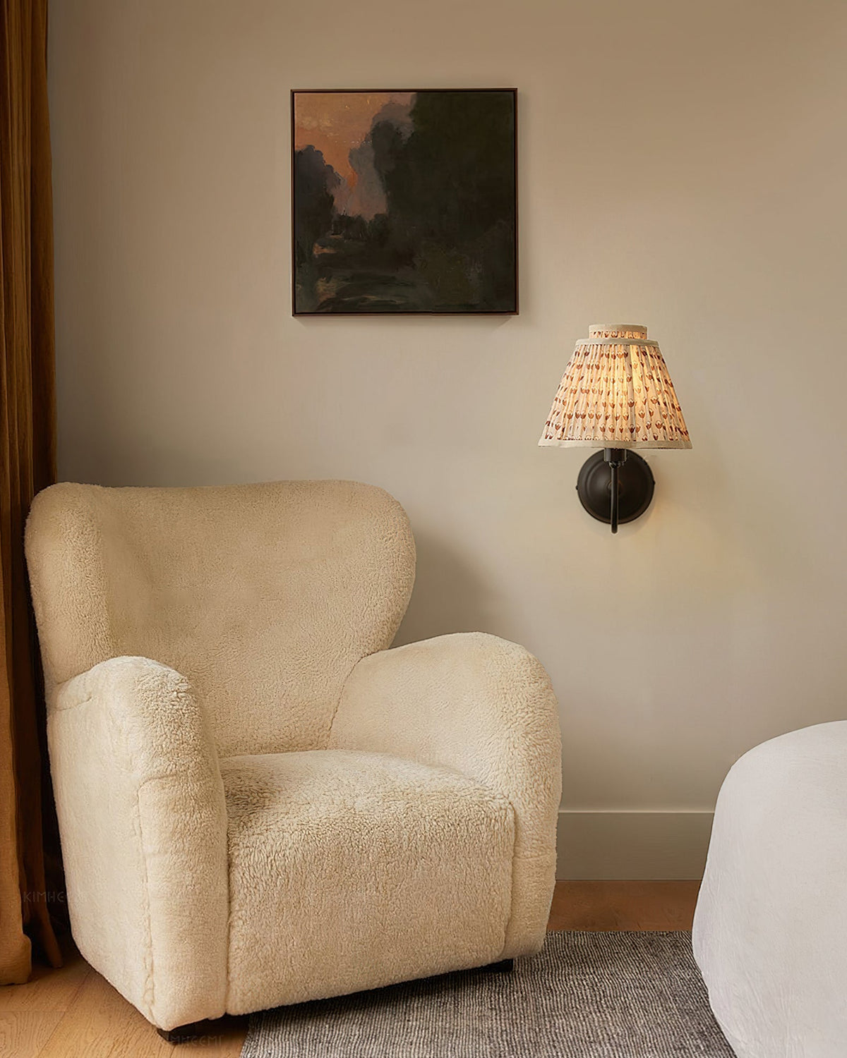 The Elbow Wall Light providing warm, ambient light in a reading nook.