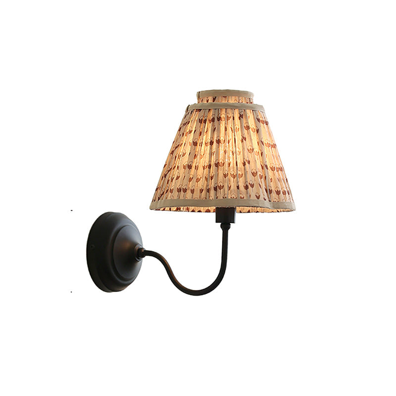The Elbow Wall Light shown turned off to highlight the fabric texture.