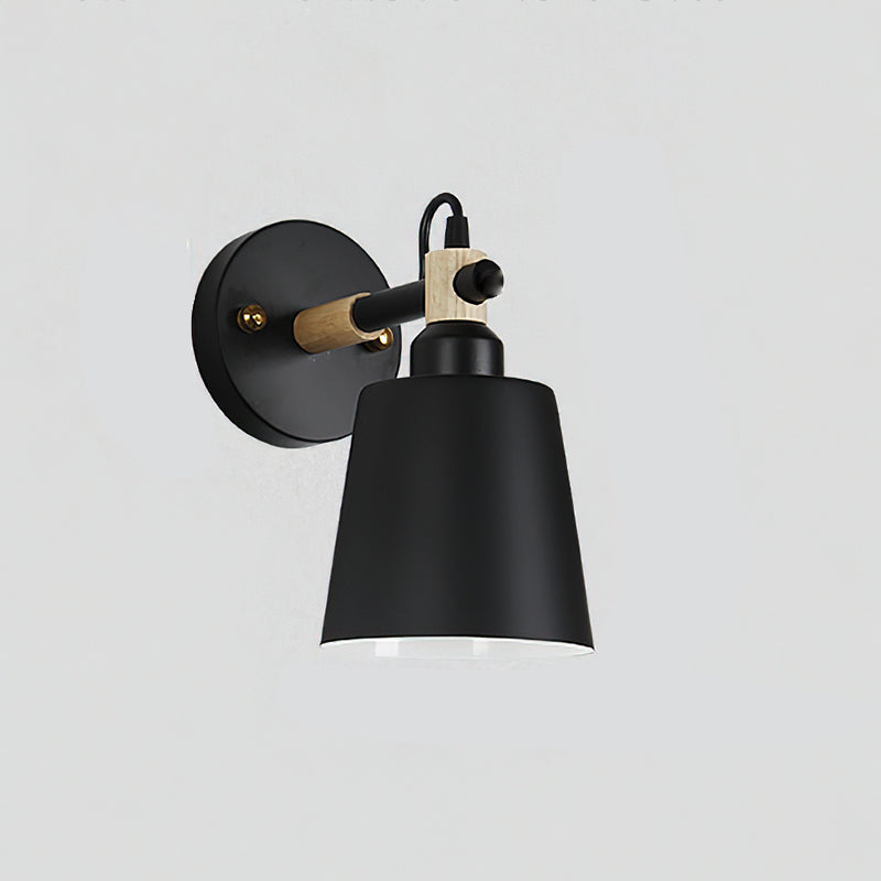 Copita Wall Lamp casting a focused beam of light on a book.