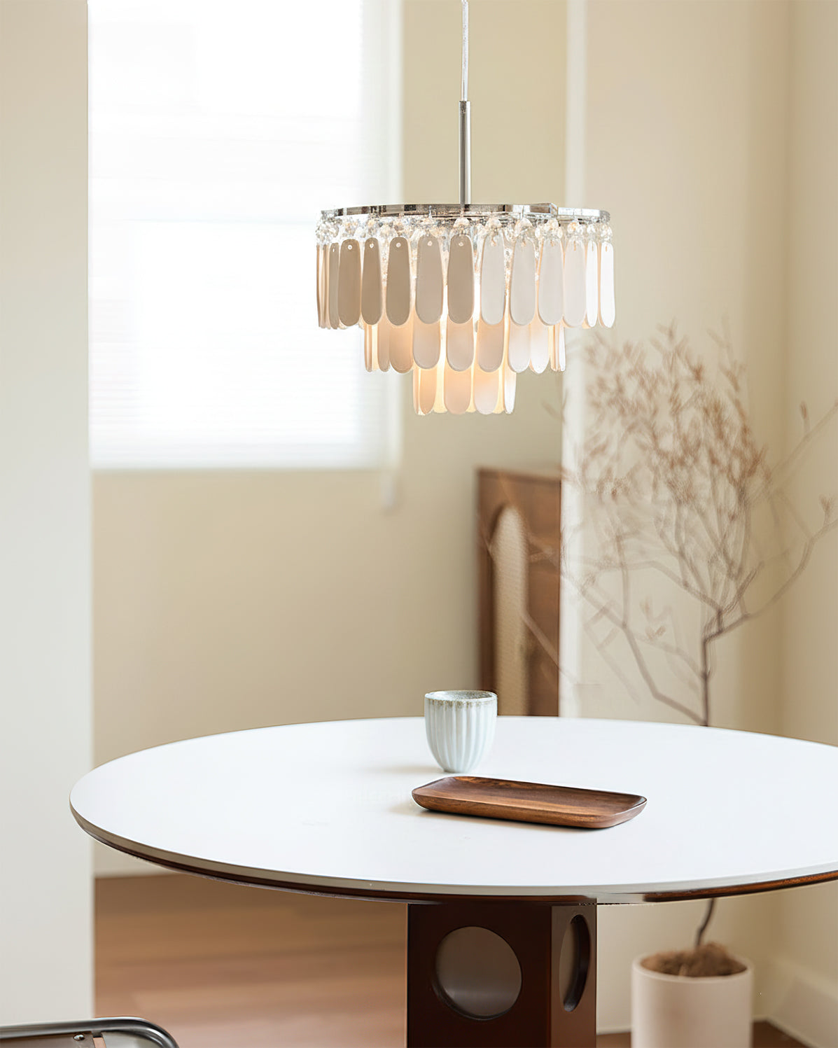 Close-up view of the tiered, hand-finished ceramic petals of the pendant light.
