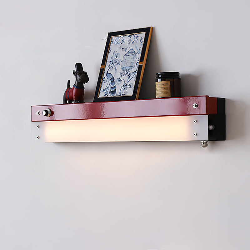 Totem Wall Lamp in red, mounted on a living room wall.