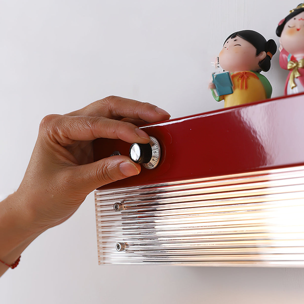 Angled view of the orange Totem Wall Lamp, highlighting its shelf feature.